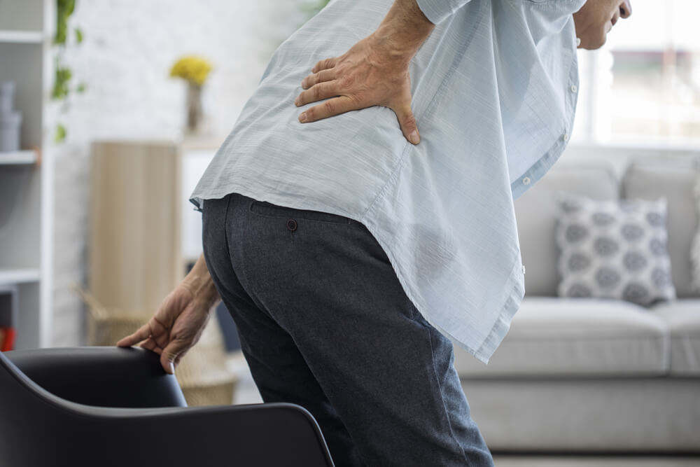 What can cause lower back and upper buttock pain?